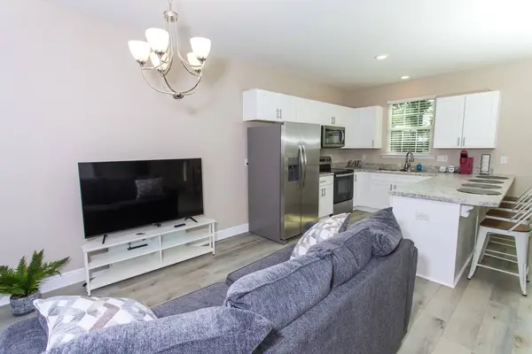 Living room with a sectional sofa and a large flat-screen TV
