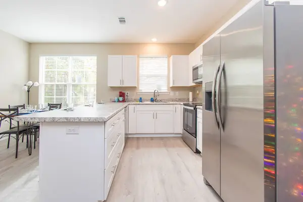 Open kitchen with a breakfast island and white cabinets