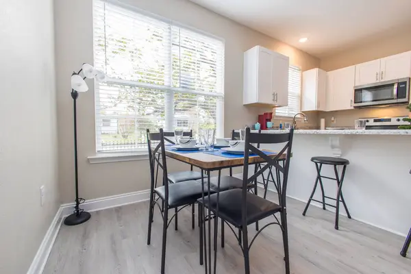 Dining table for four beside a bright window