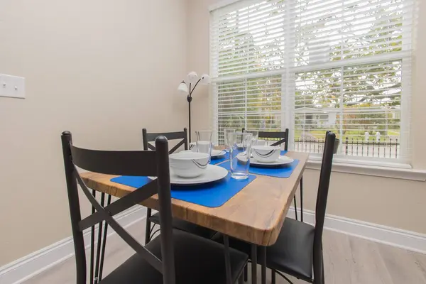 Dining table set for four next to the kitchen