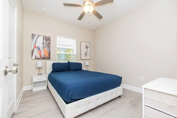Bedroom with a double bed, ceiling fan and a window