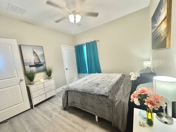 Second bedroom with a double bed and teal curtains