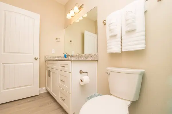 Bathroom with a large mirror, vanity and fresh towels