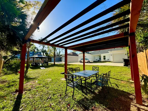 Large pergola with an outdoor table and chairs
