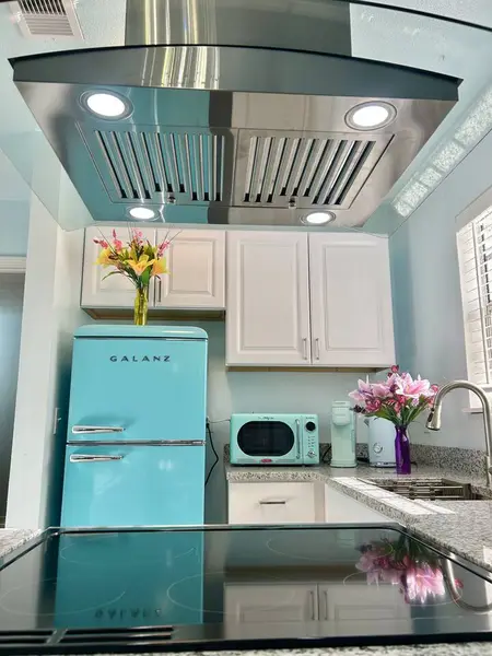 Kitchen with a retro mint fridge and microwave