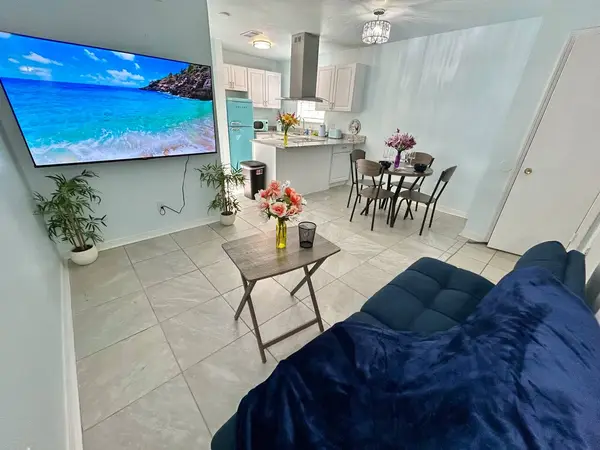Living area with a sofa and a large TV
