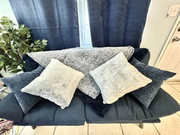 Sofa with cushions and a throw