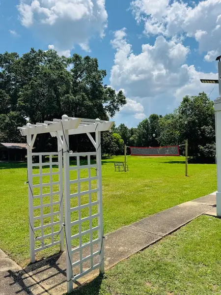 White arbour on the shared lawn
