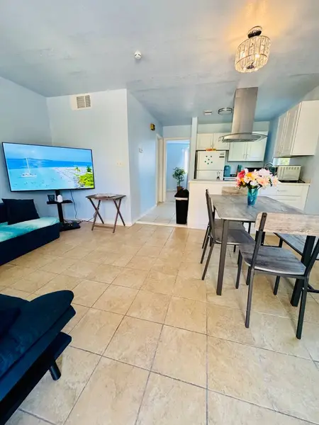Living and dining area with a large TV