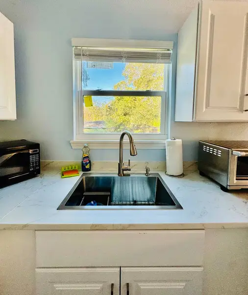 Kitchen sink beneath a bright window