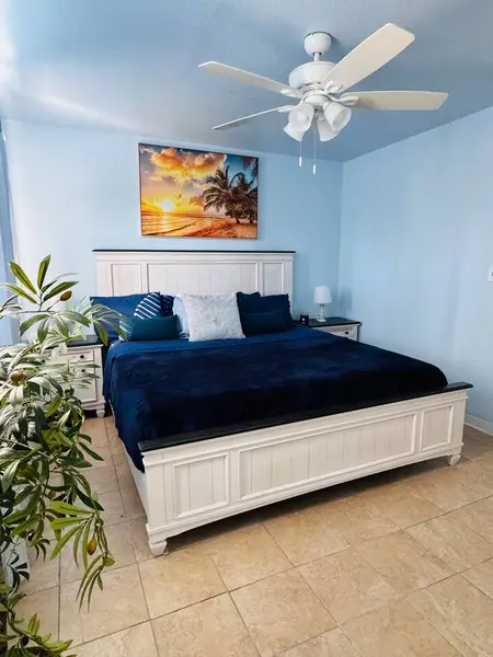 Bedroom with a king bed and framed art