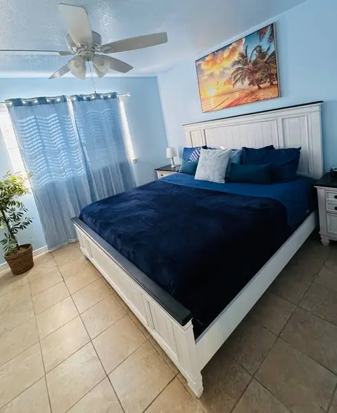 Bedroom with a king bed and light curtains