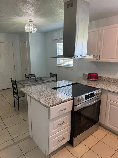 Kitchen with a cooktop and range hood