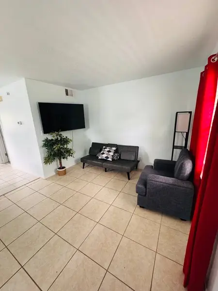 Living area with a wall-mounted TV and sofa