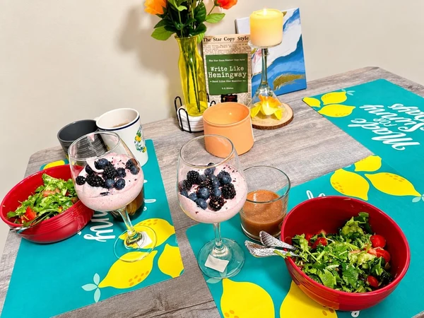 Breakfast of berry parfaits and salads on lemon placemats