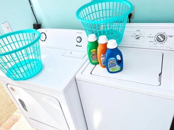 Washer and dryer with laundry baskets and detergent