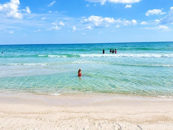 Swimmers in the clear Gulf water at Pensacola Beach