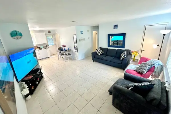Living and dining area with a large TV
