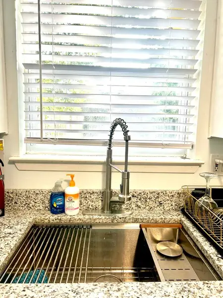 Kitchen sink beneath a bright window