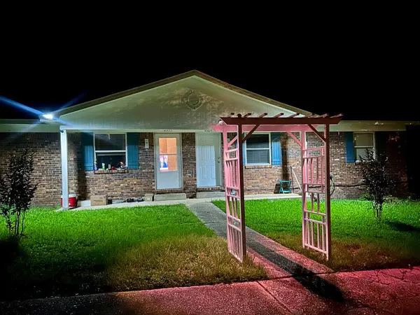 Front of the duplex lit up at night