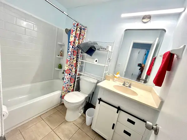 Bathroom with a shower over the bath