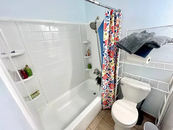 Second bathroom with a shower over the bath