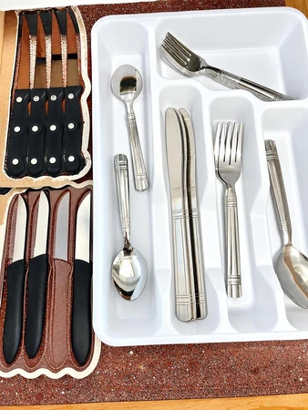 Utensil drawer with forks, spoons and steak knives