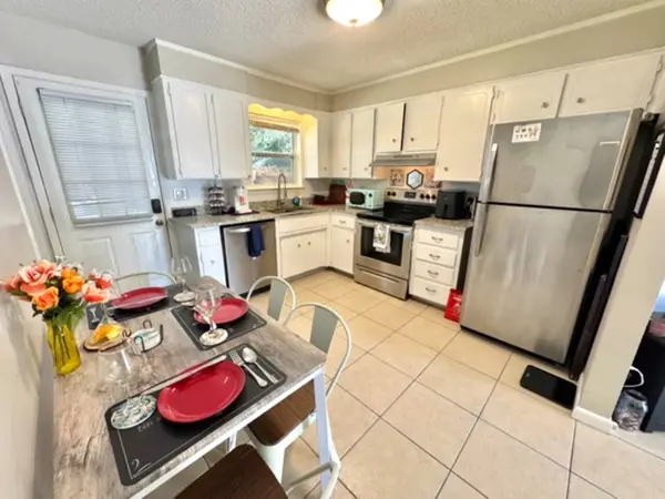 Kitchen with a fridge and dining table