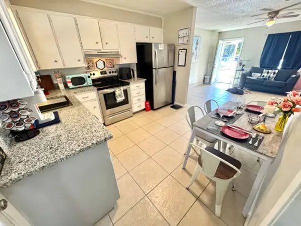 Kitchen with an electric stove and fridge