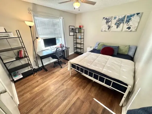 Bedroom with a king bed and a workspace