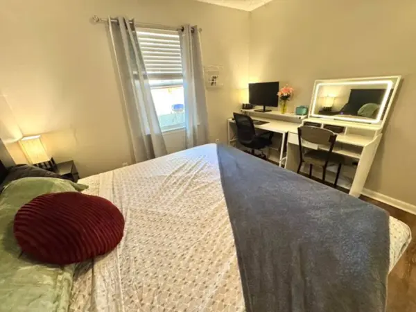 Bedroom with a bed and a desk by the window