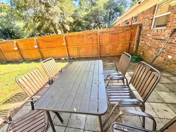 Fenced backyard with a patio dining set