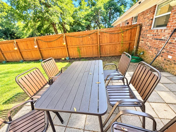 Patio dining table for six along the fenced side yard